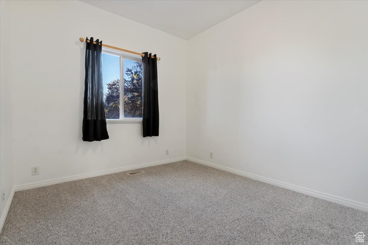 Spare room featuring carpet