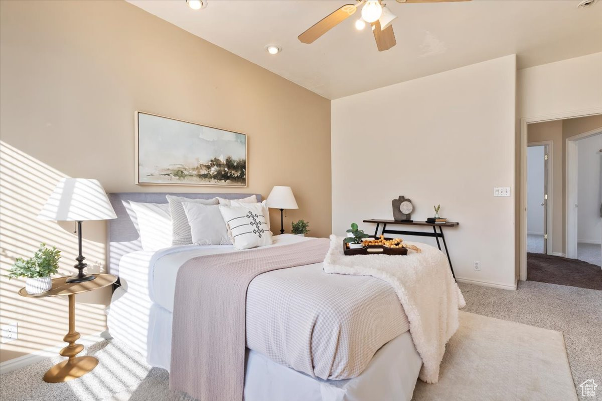 Carpeted bedroom with ceiling fan