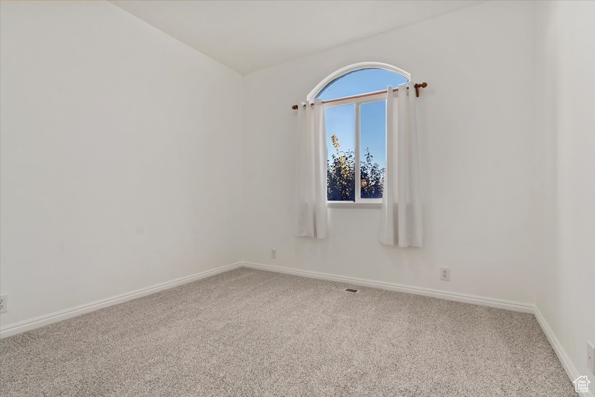 Unfurnished room featuring carpet flooring