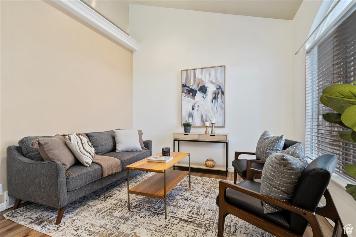 Living room with hardwood / wood-style flooring and vaulted ceiling