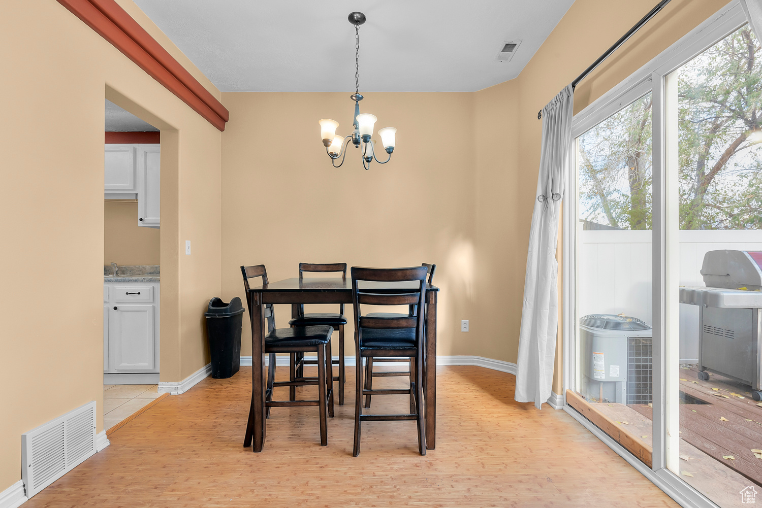 Dining space featuring light hardwood / wood-style flooring and a chandelier