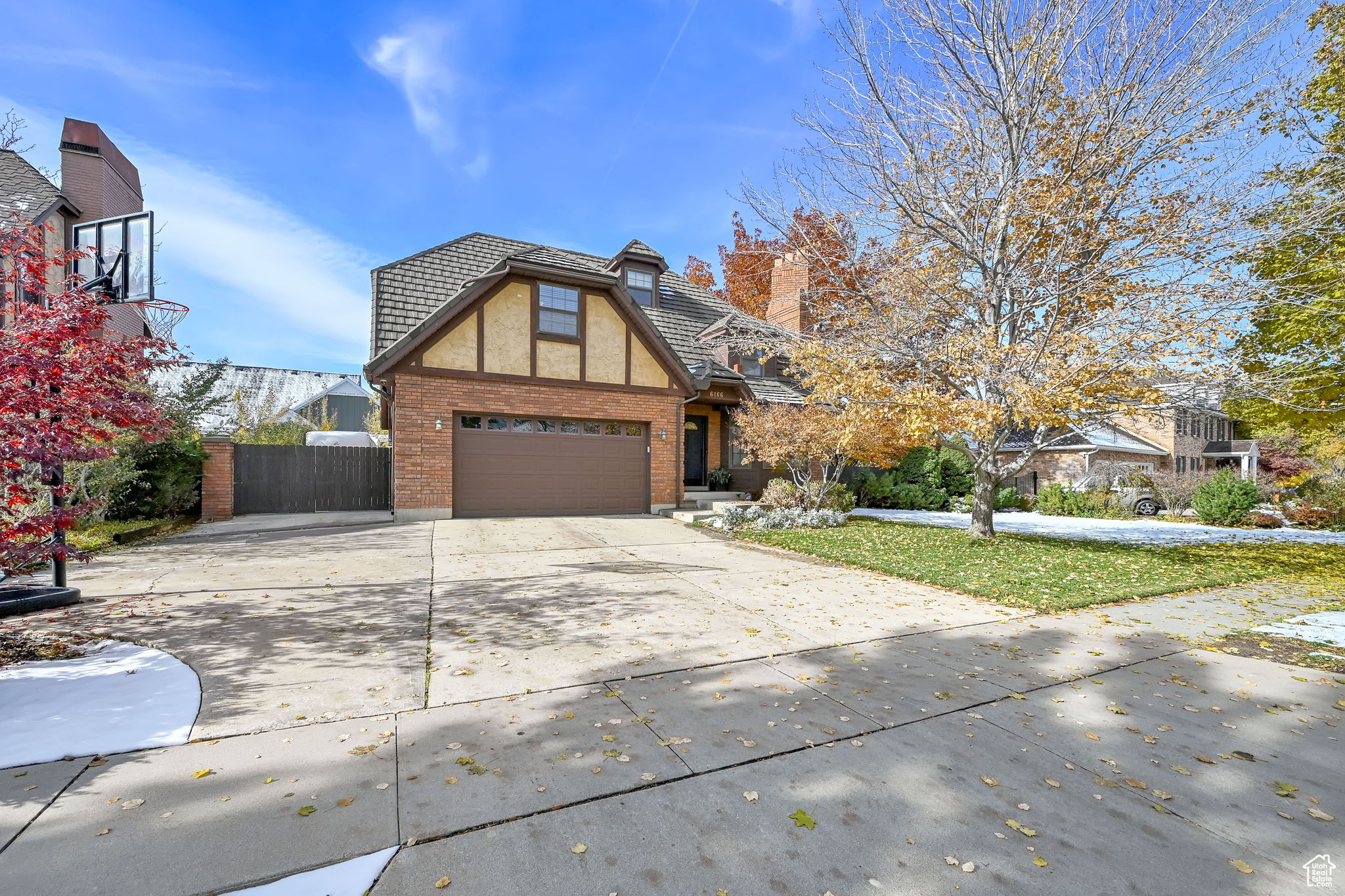 View of front of home with a front yard and a garage