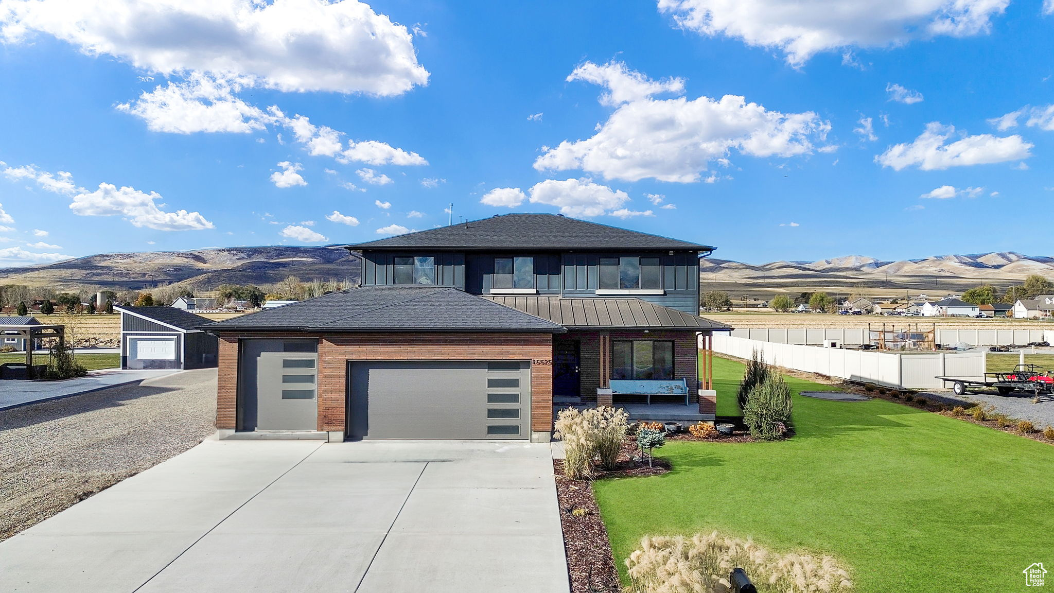 Prairie-style house featuring a mountain view, a garage, and a front yard