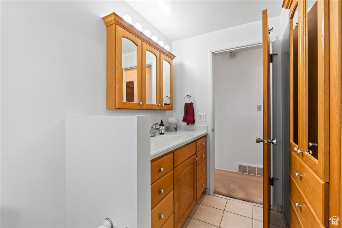 Bathroom featuring tile patterned floors and vanity