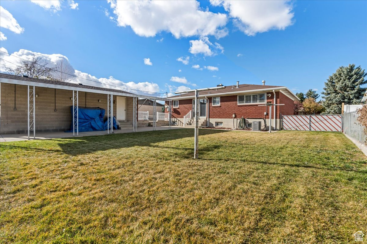 Rear view of house with a lawn