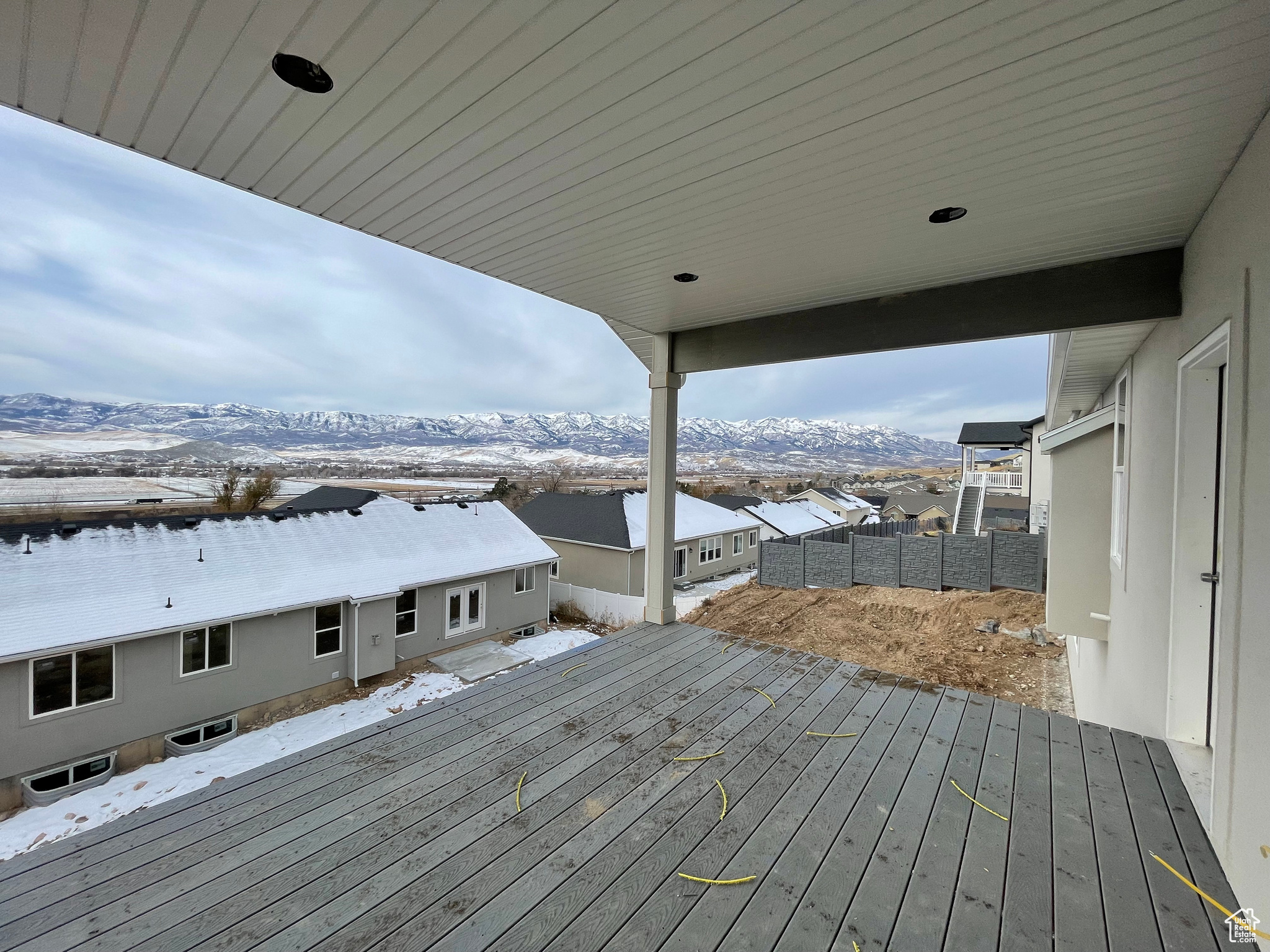 Snow covered deck with a mountain view