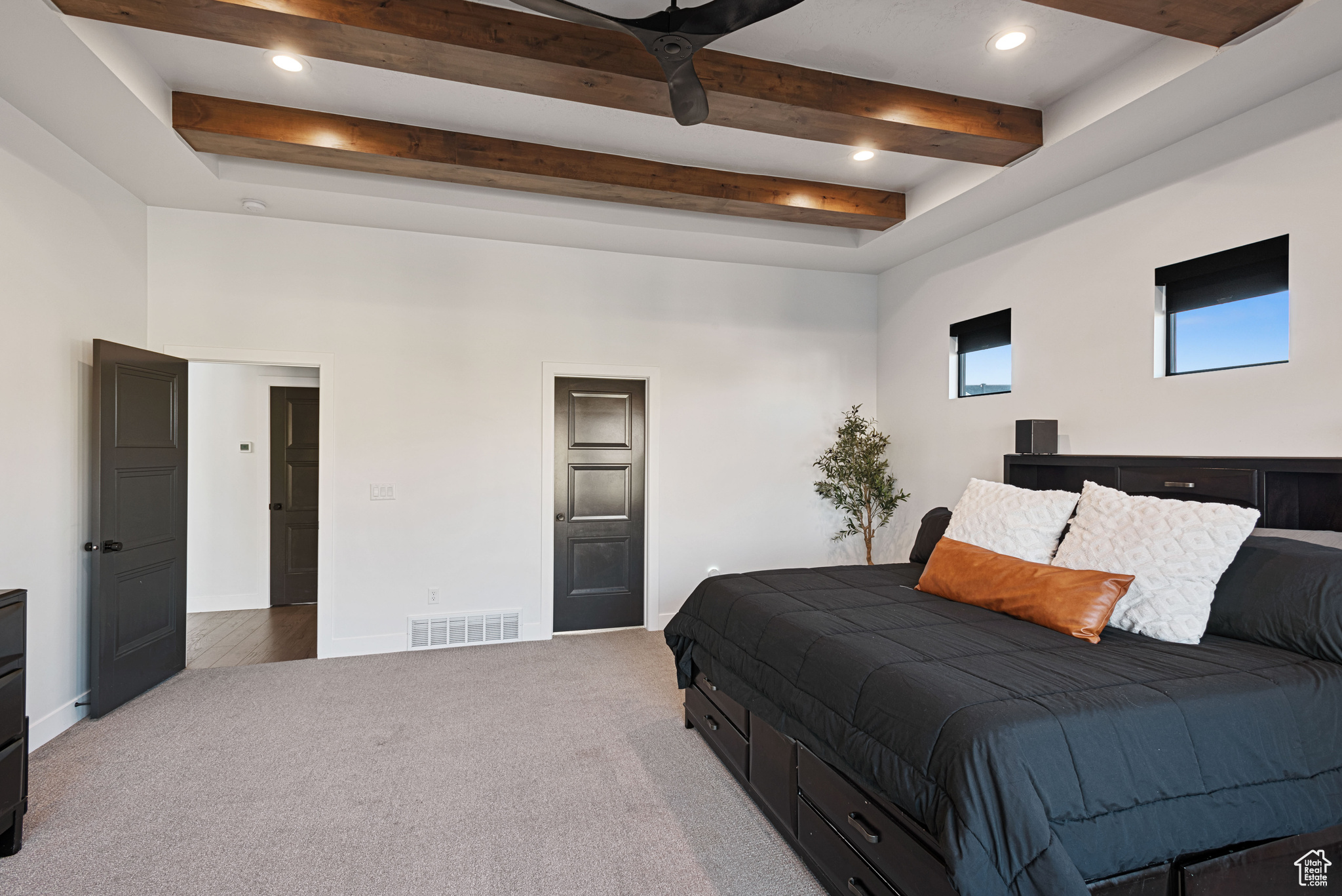 Bedroom featuring carpet flooring and beam ceiling