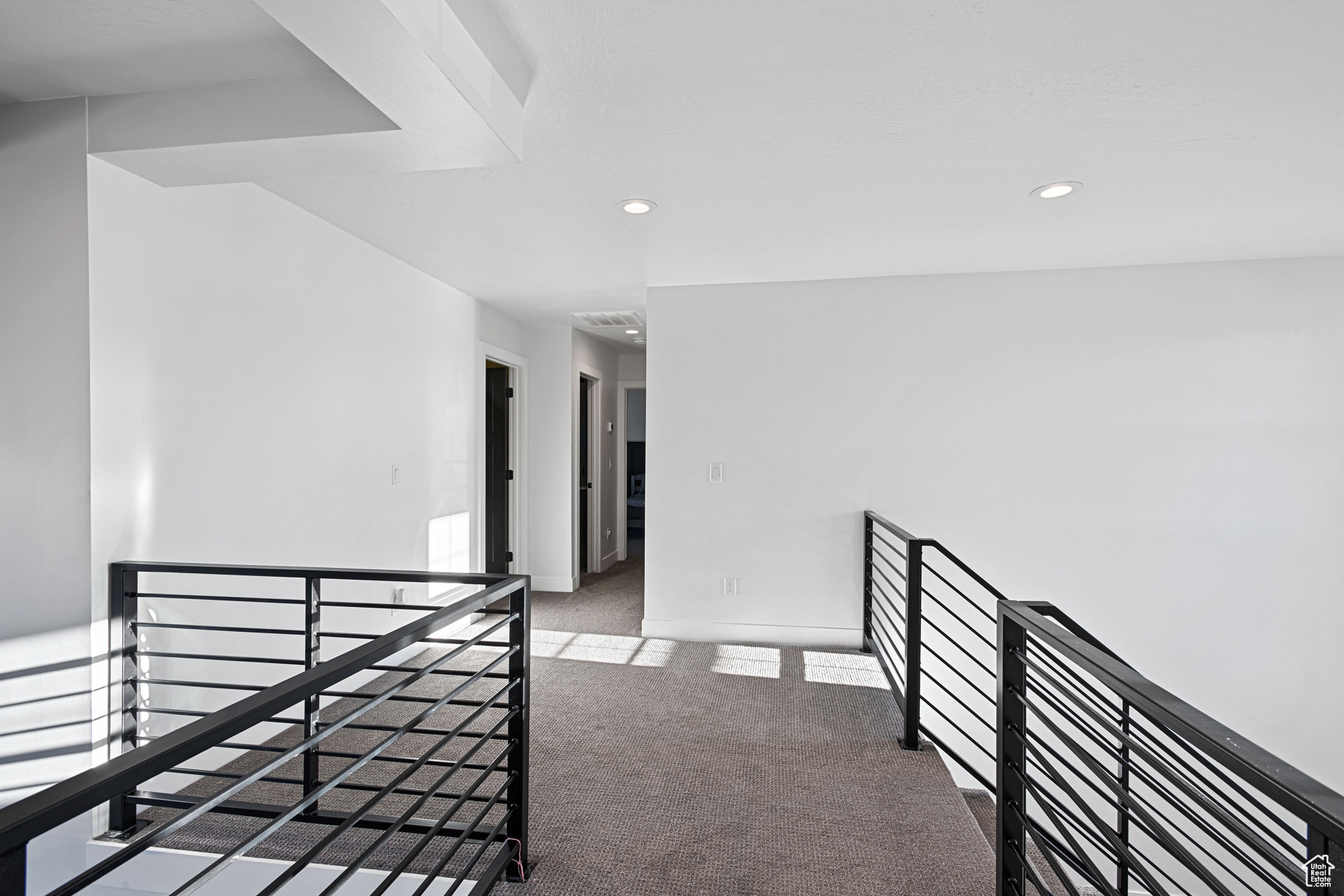 Corridor with light colored carpet