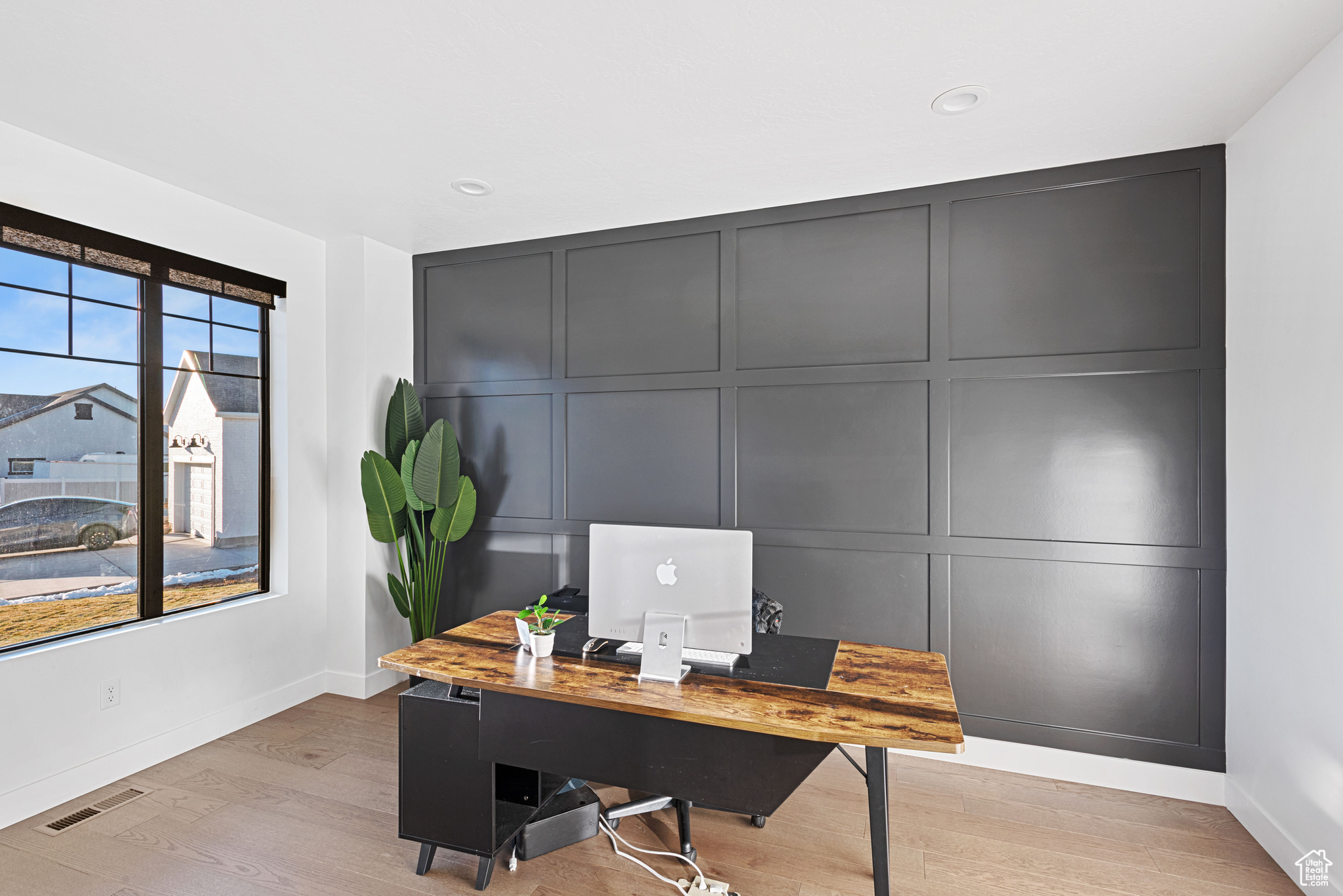 Office space with light hardwood / wood-style flooring