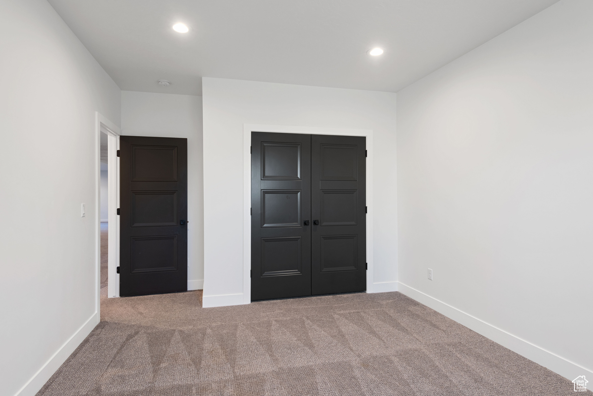 Unfurnished bedroom featuring a closet and carpet floors