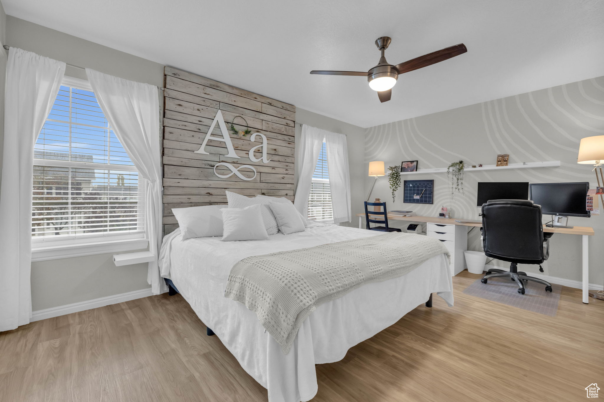 Master bedroom featuring light wood-type flooring and ceiling fan