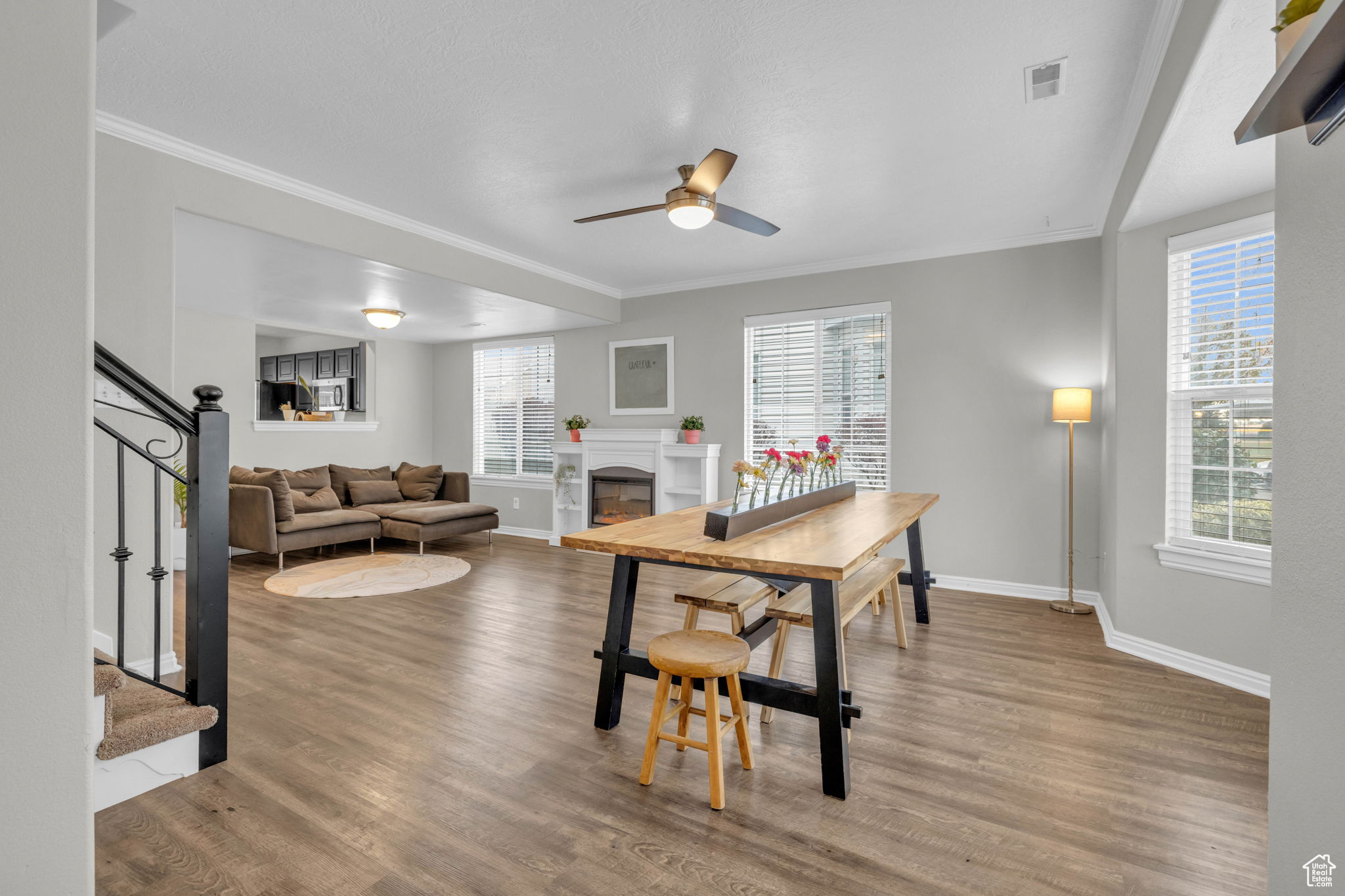 Dining area with ceiling fan, crown molding and LVP flooring