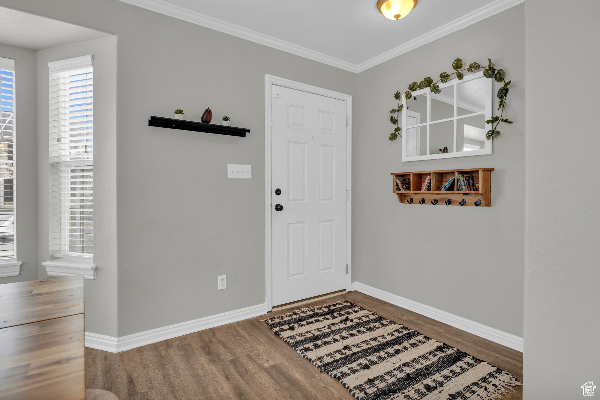 Entrance featuring LVP and crown molding