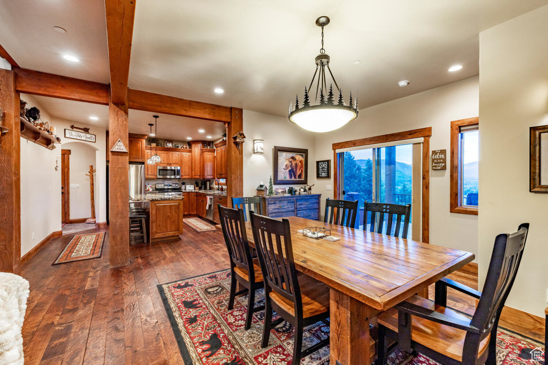 Dining space featuring beam ceiling and dark hardwood / wood-style flooring