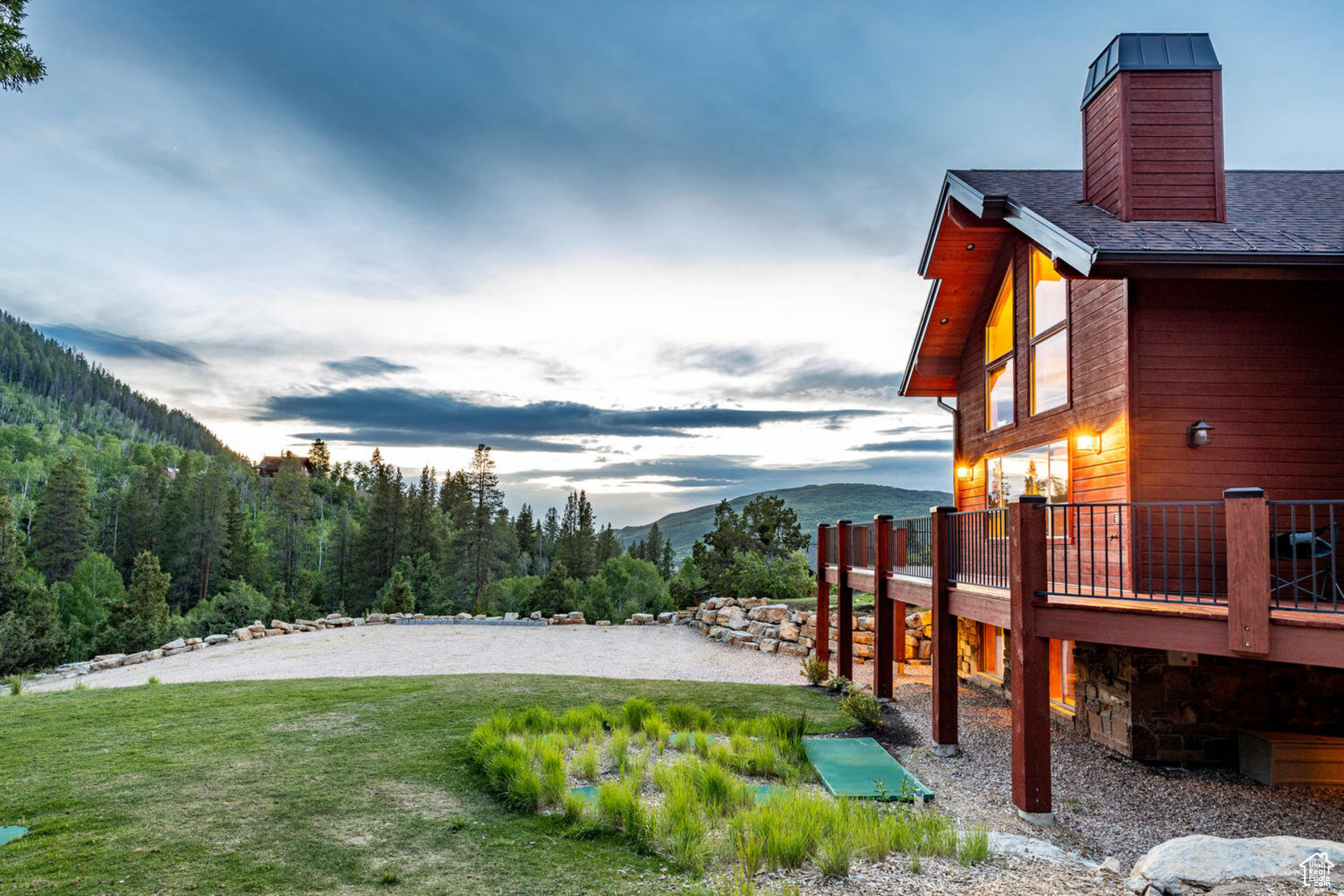 Yard at dusk featuring a deck with mountain view