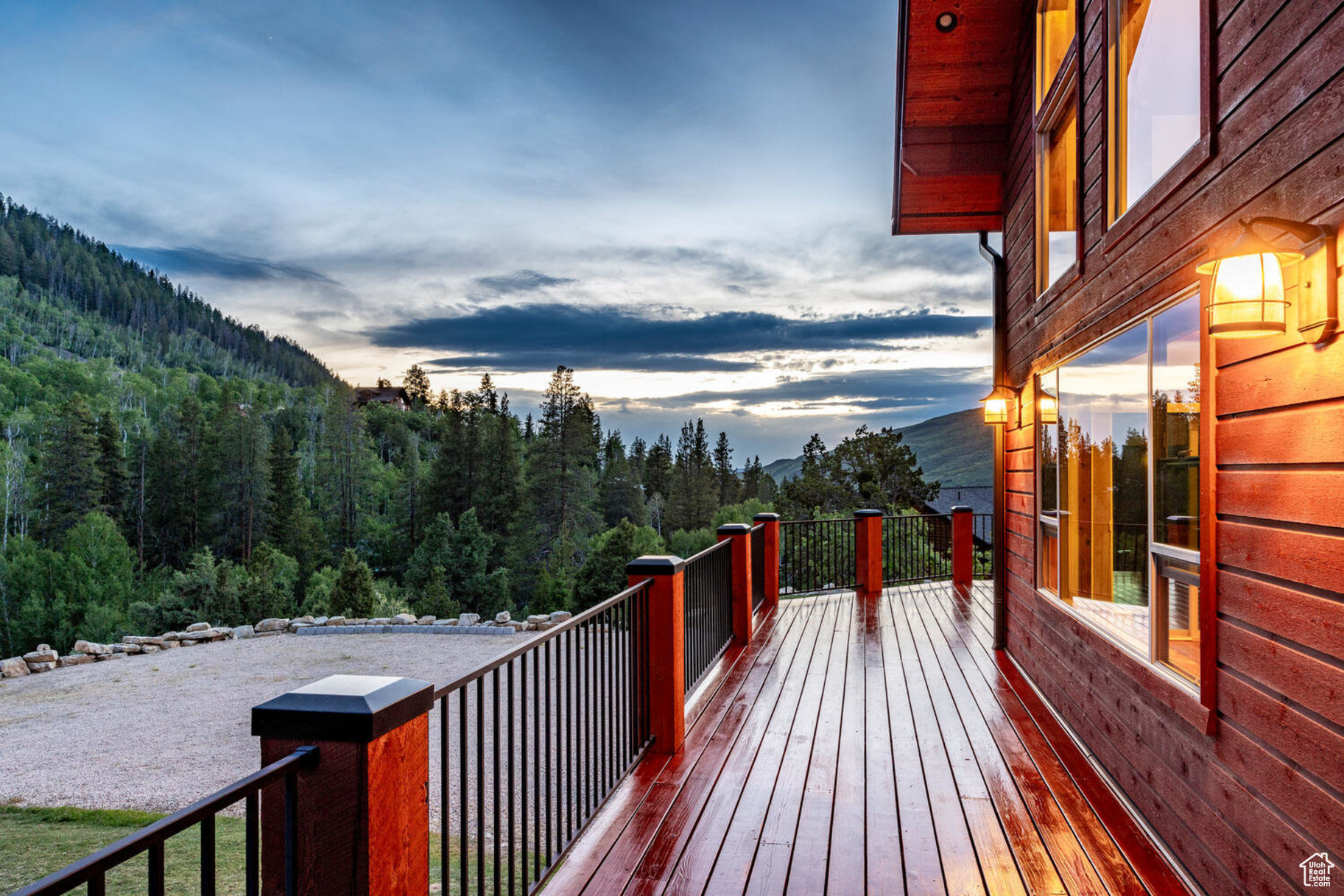 Deck at dusk featuring a mountain view