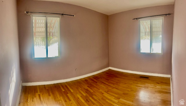 Unfurnished room with hardwood / wood-style floors