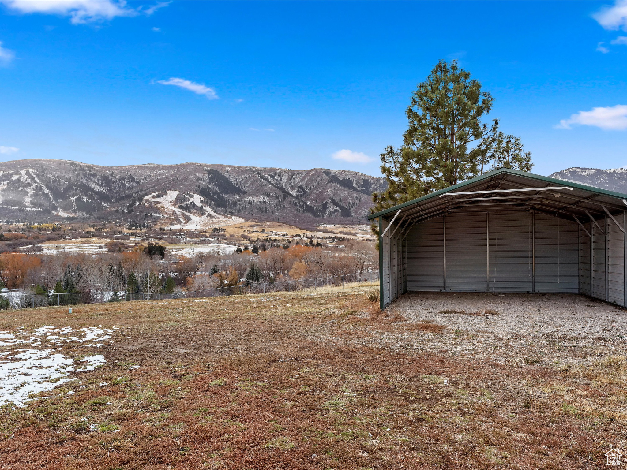 Garage featuring a mountain view and a carport