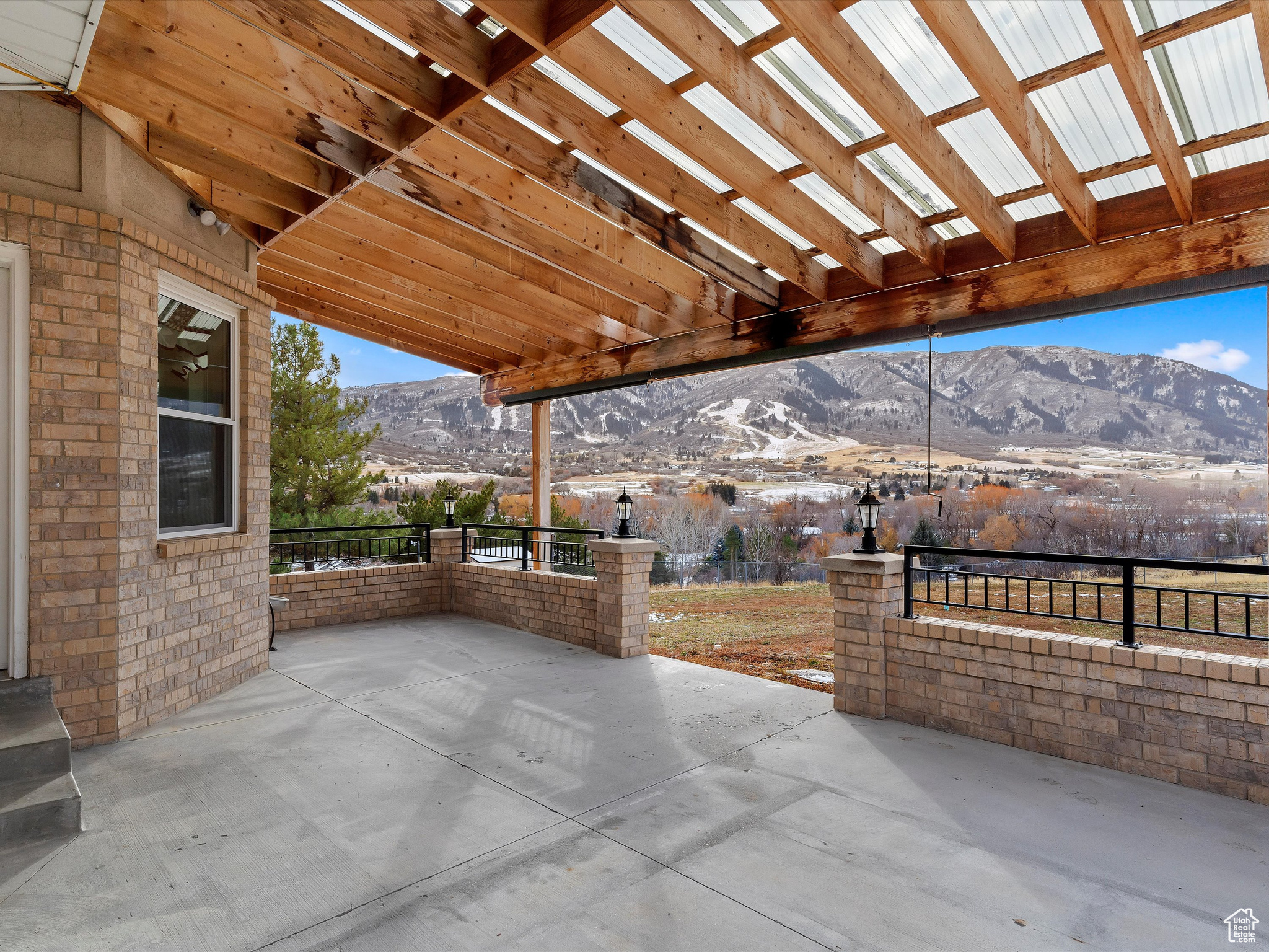 View of patio with a mountain view and a pergola