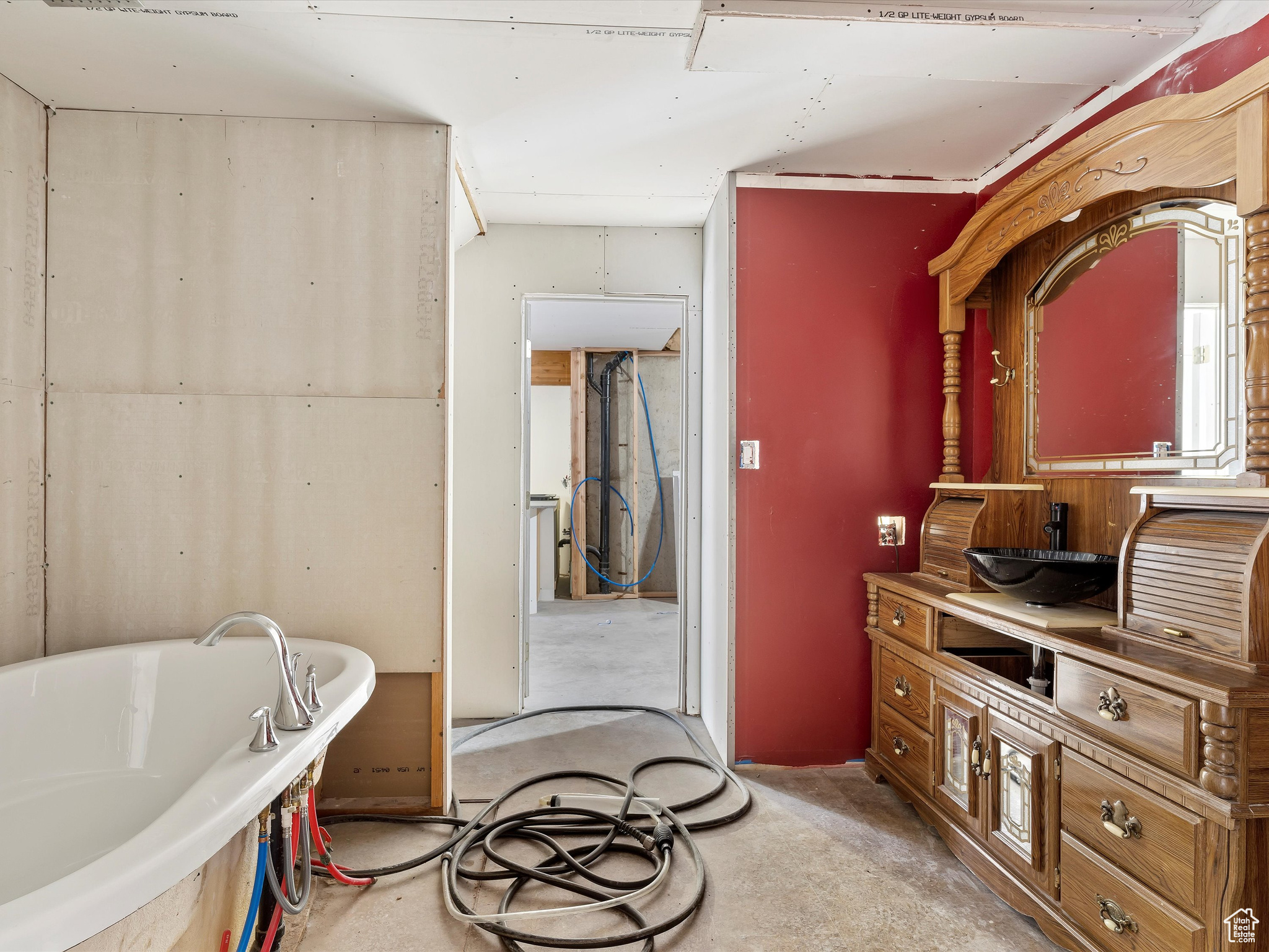 Bathroom with a tub and concrete floors