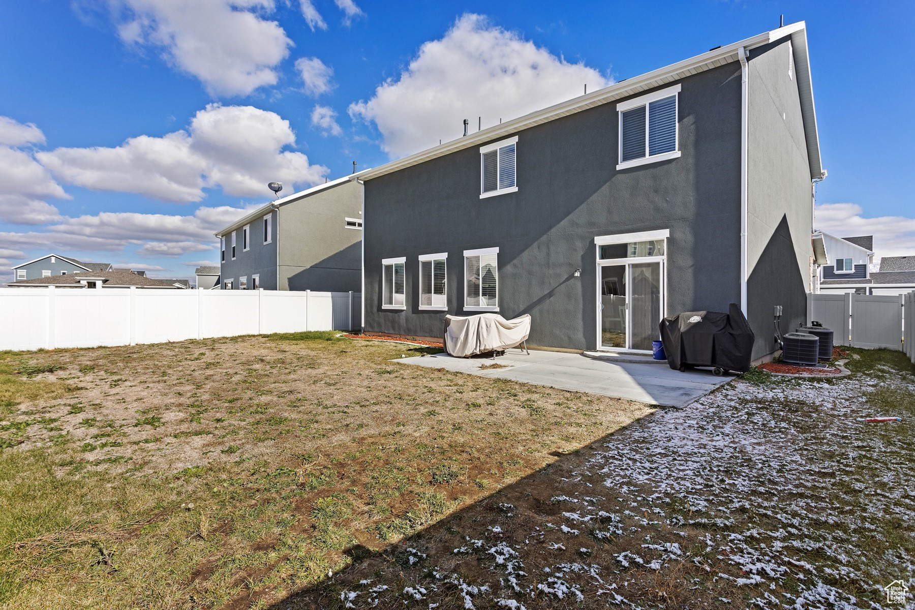 Back of property featuring a yard, cooling unit, and a patio area