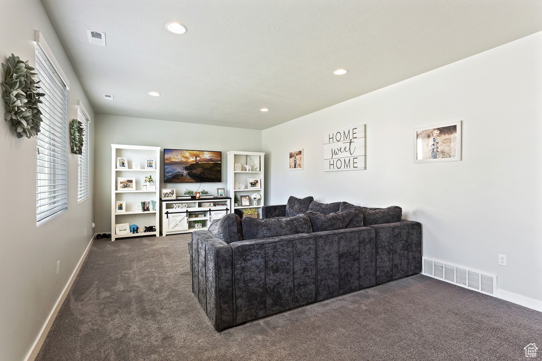 Living room featuring dark colored carpet