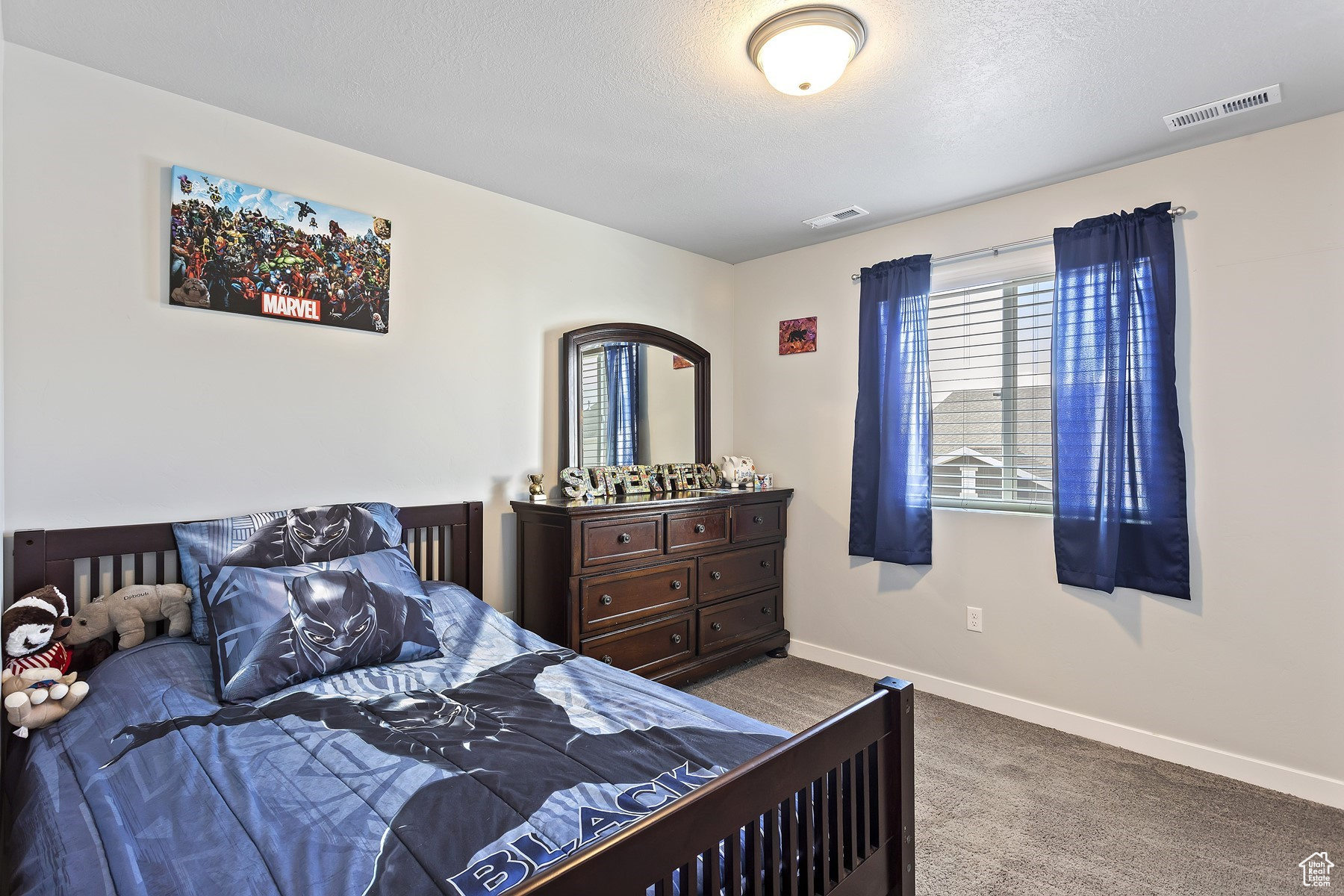 Bedroom with carpet floors and a textured ceiling