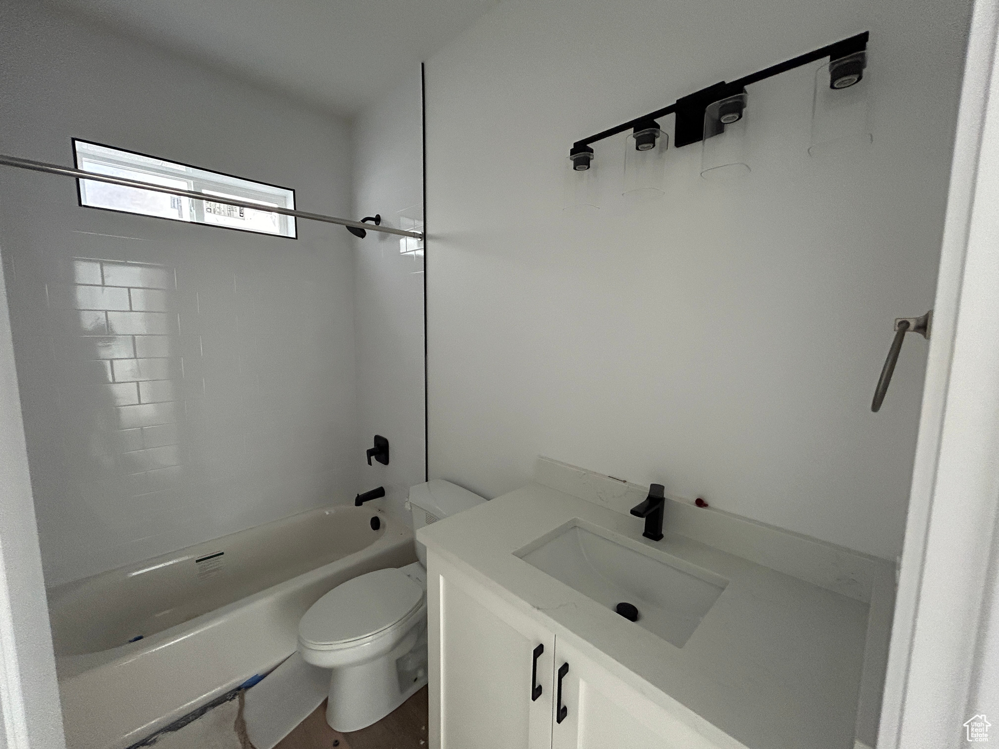 Full bathroom featuring vanity,  shower combination, and toilet