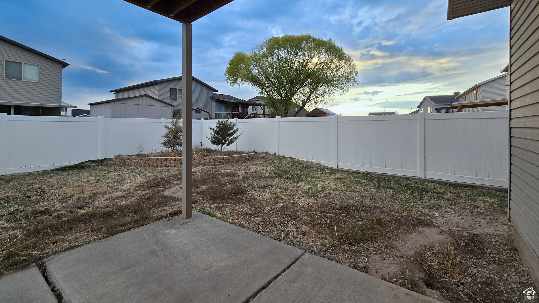 Yard at dusk featuring a patio