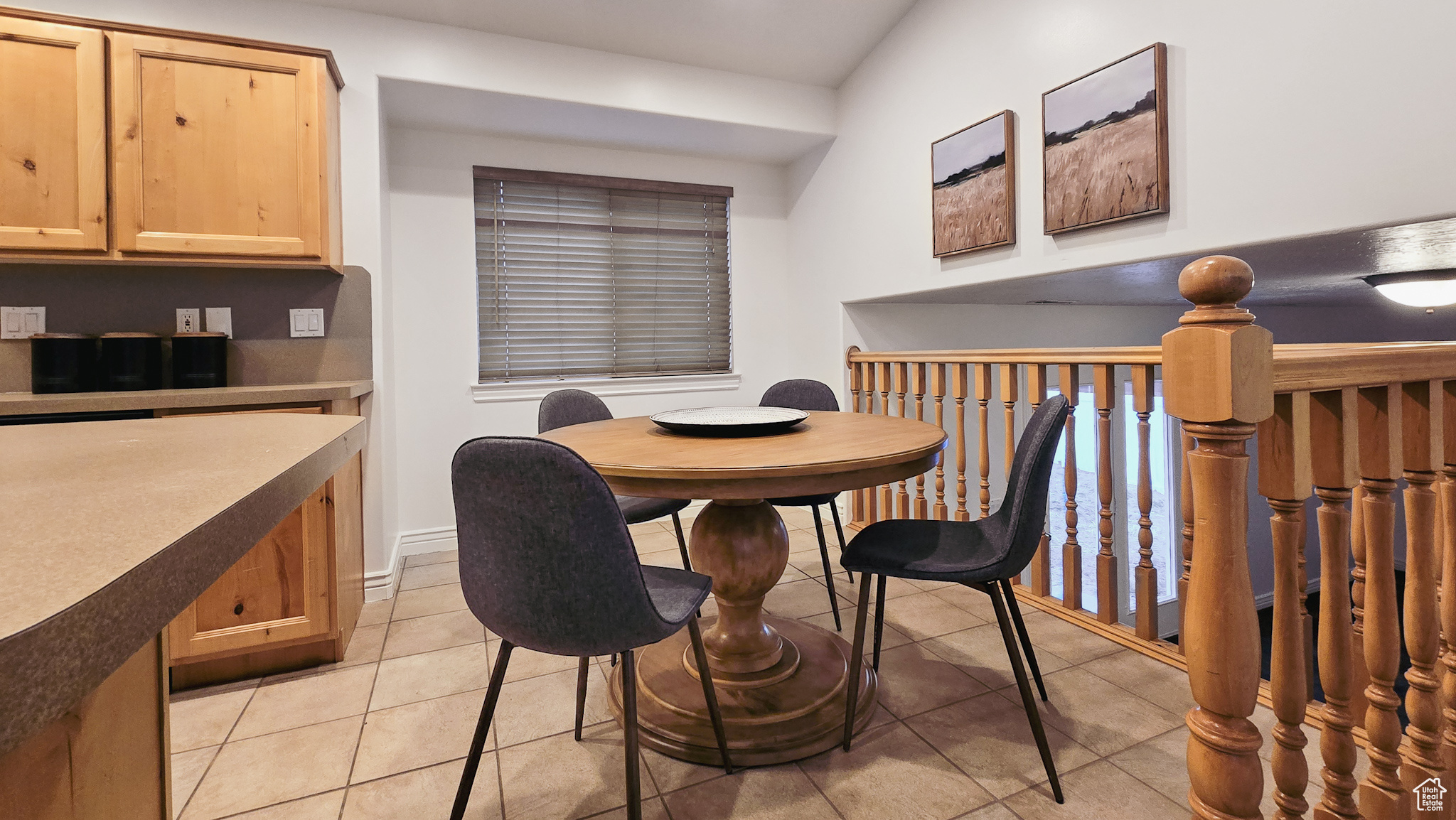 Dining space with light tile patterned floors