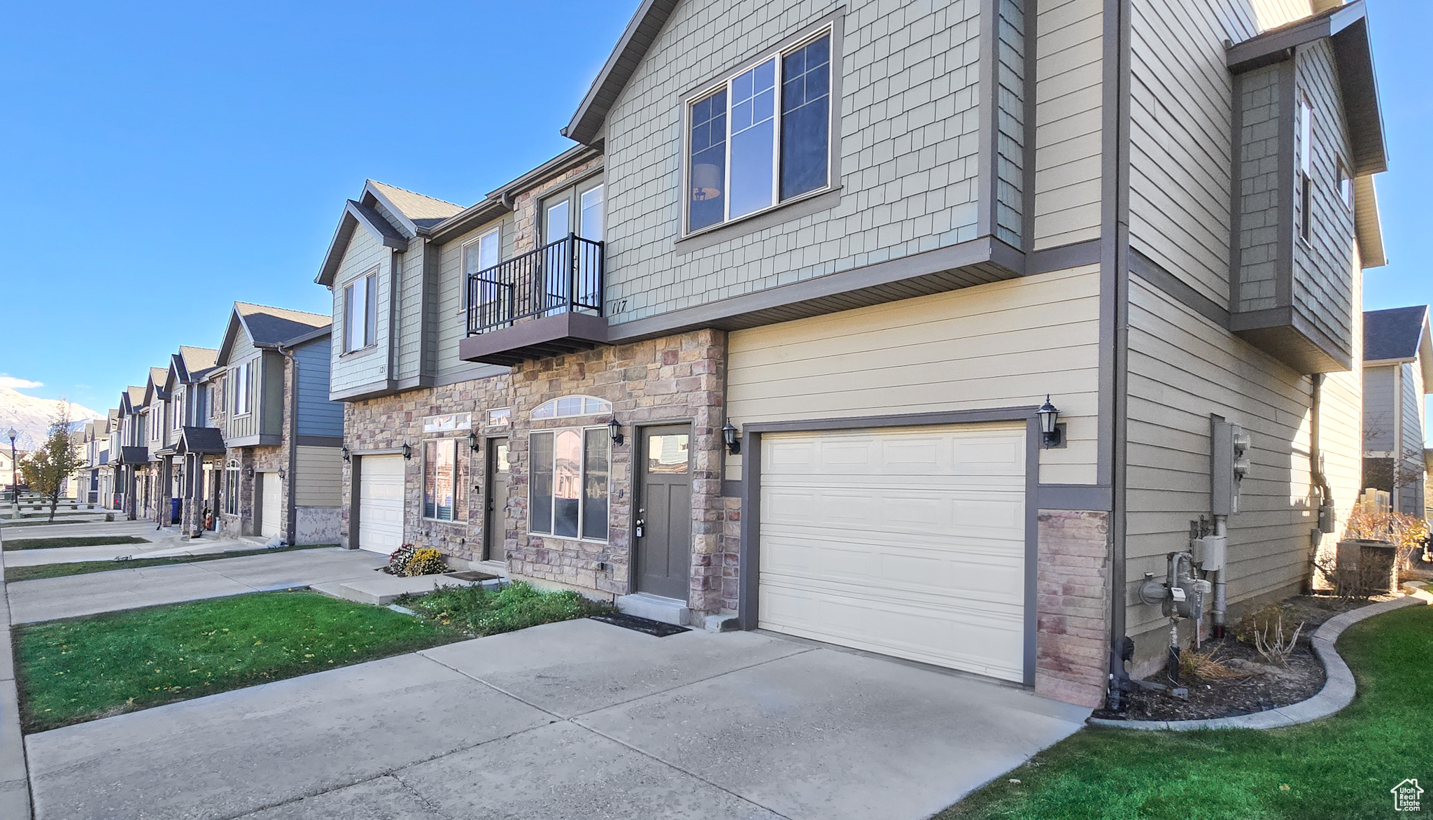 View of front of home with a balcony and a garage