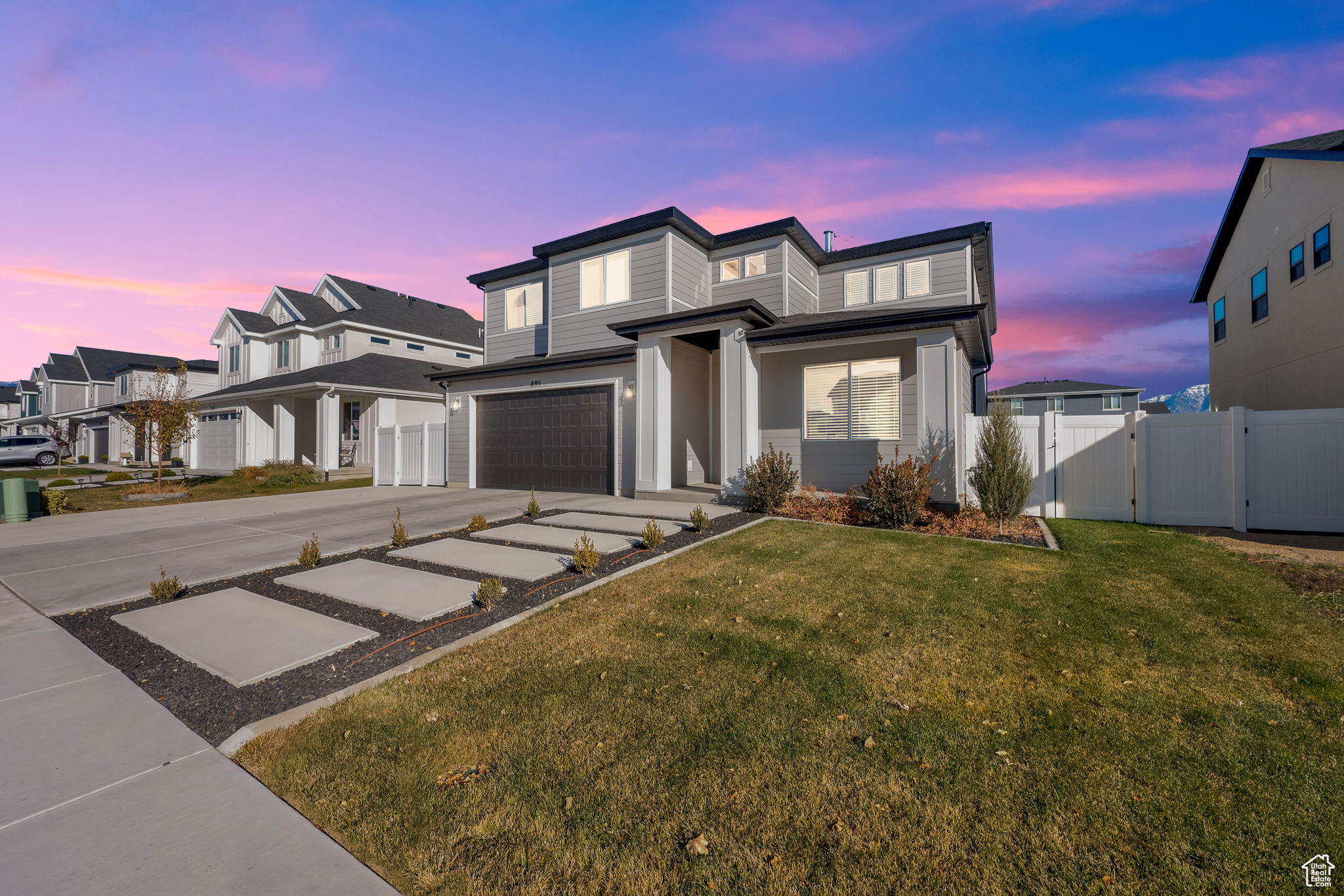 View of front of home with a lawn and a garage