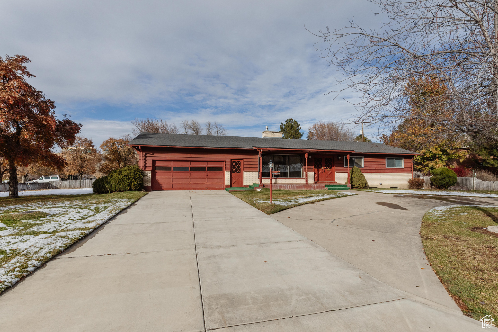 Single story home featuring a porch and a garage