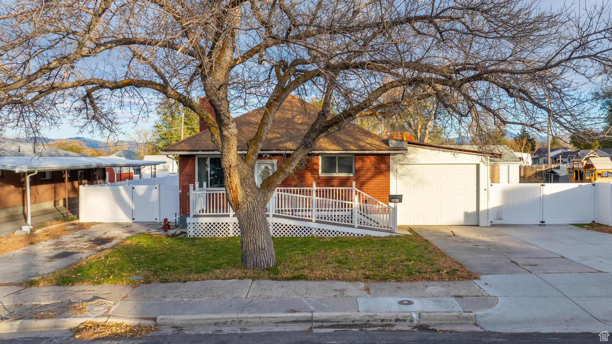 View of front of house with a garage and a front lawn