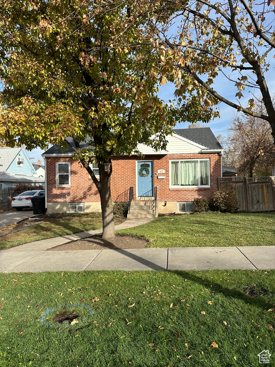 View of front of house featuring a front lawn and cooling unit