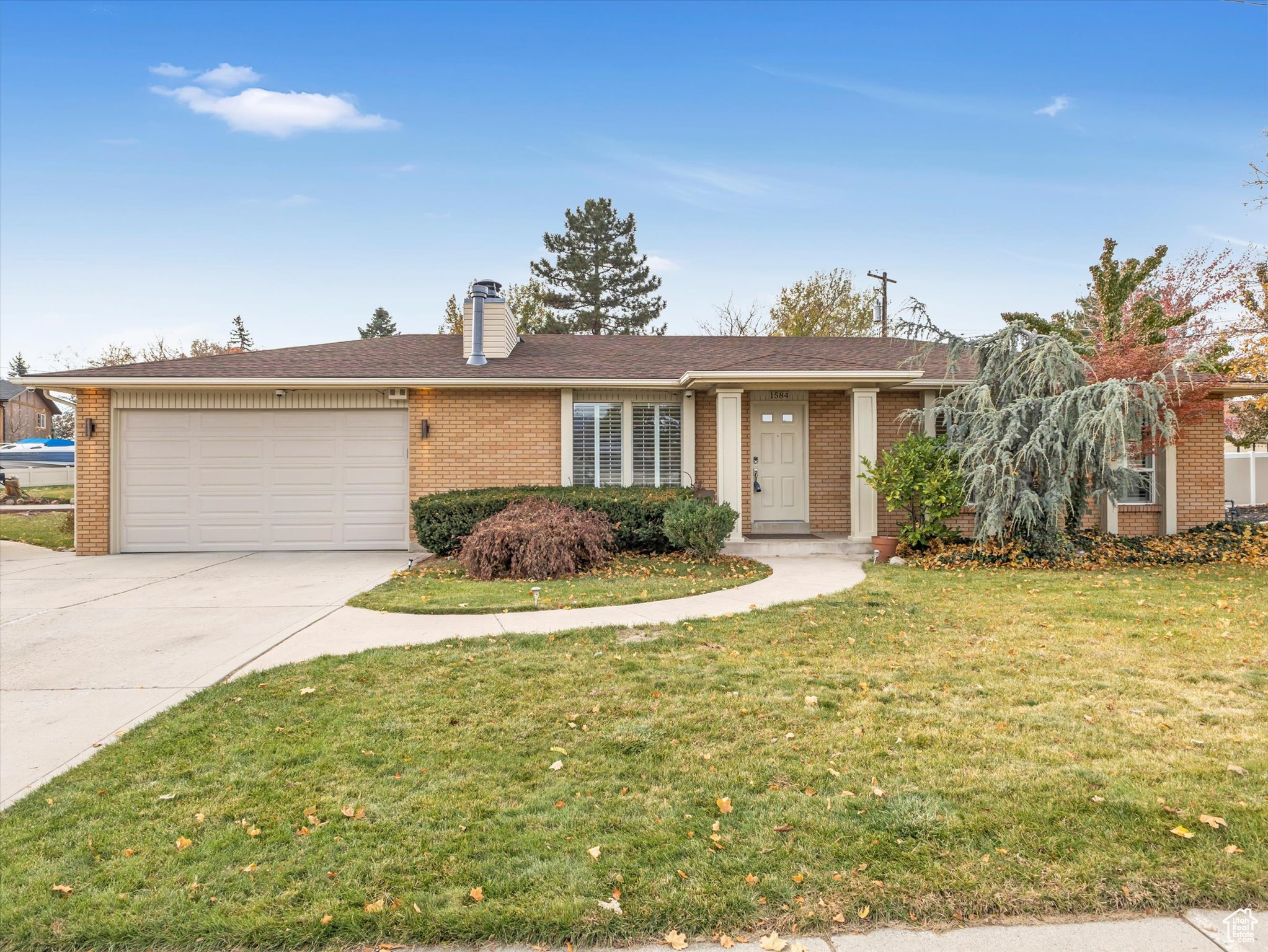 Single story home with a front yard and a garage