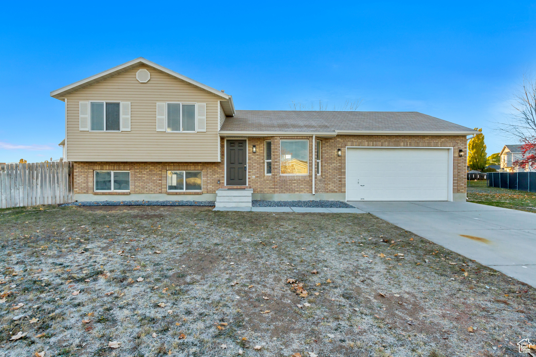 Tri-level home with a front yard and a garage