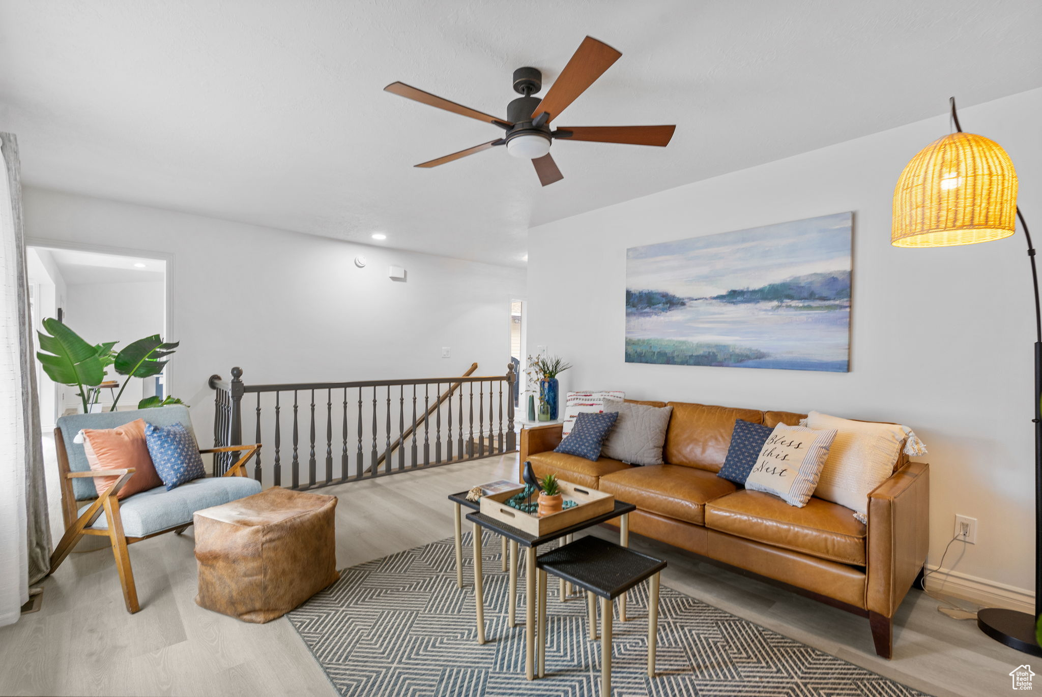 Living room featuring ceiling fan and wood-type flooring