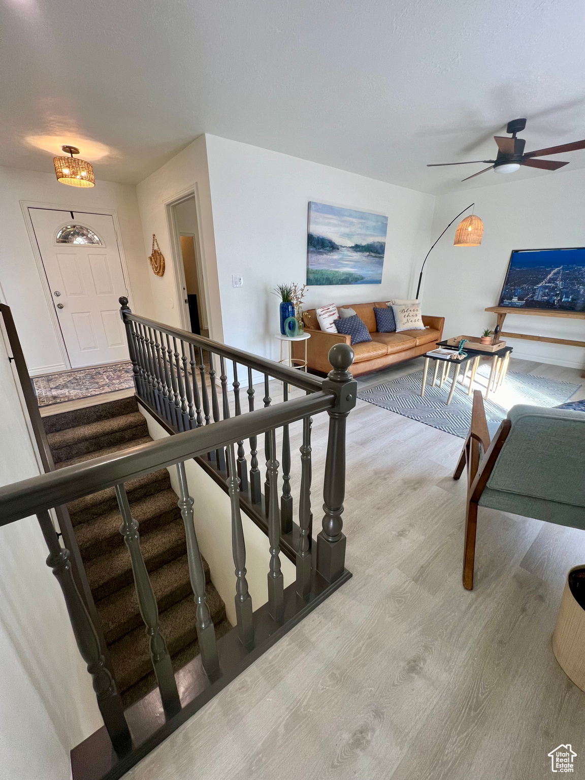 Interior space with ceiling fan and light hardwood / wood-style flooring