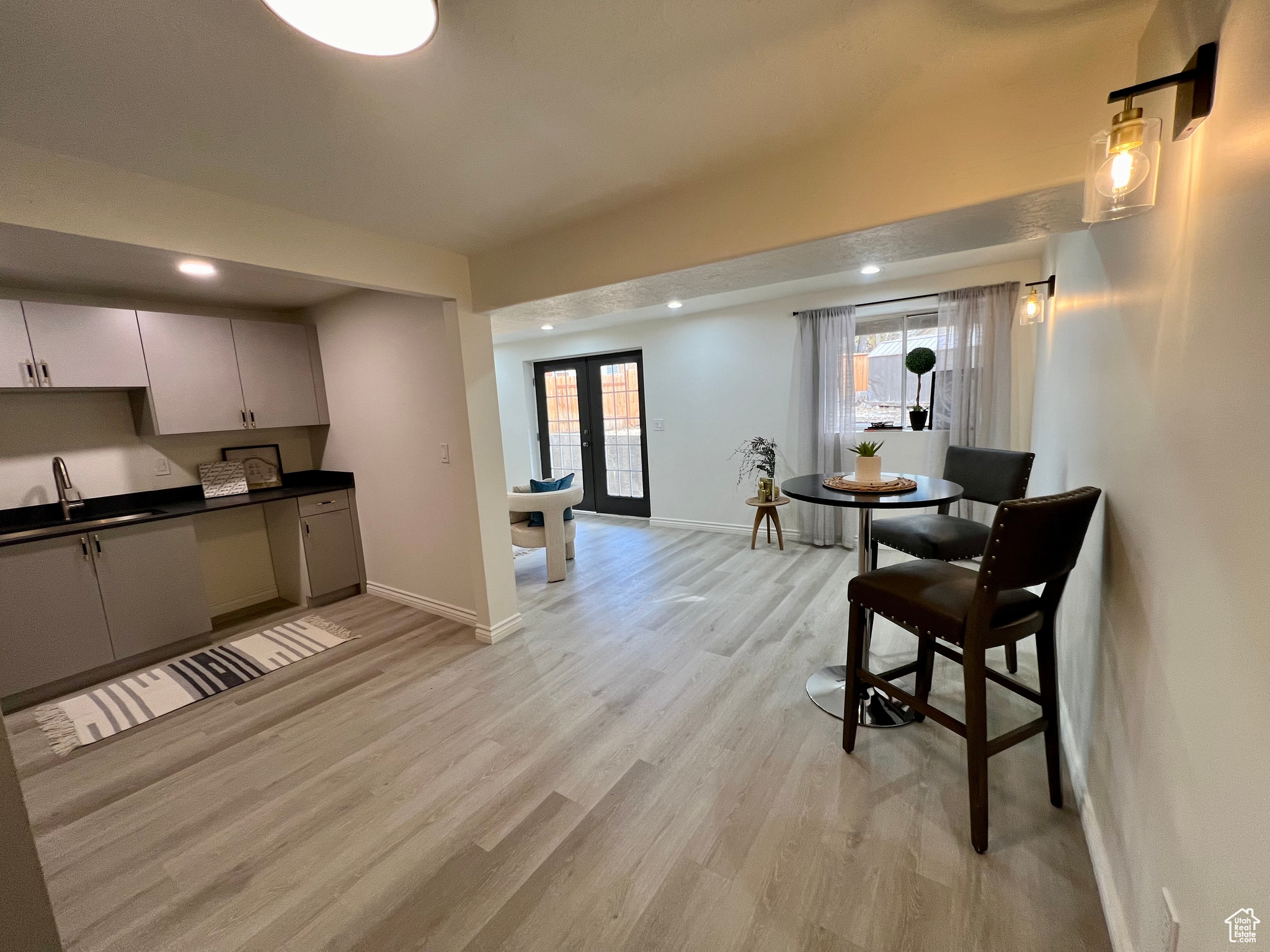 Kitchen featuring light wood-type flooring, sink, and french doors