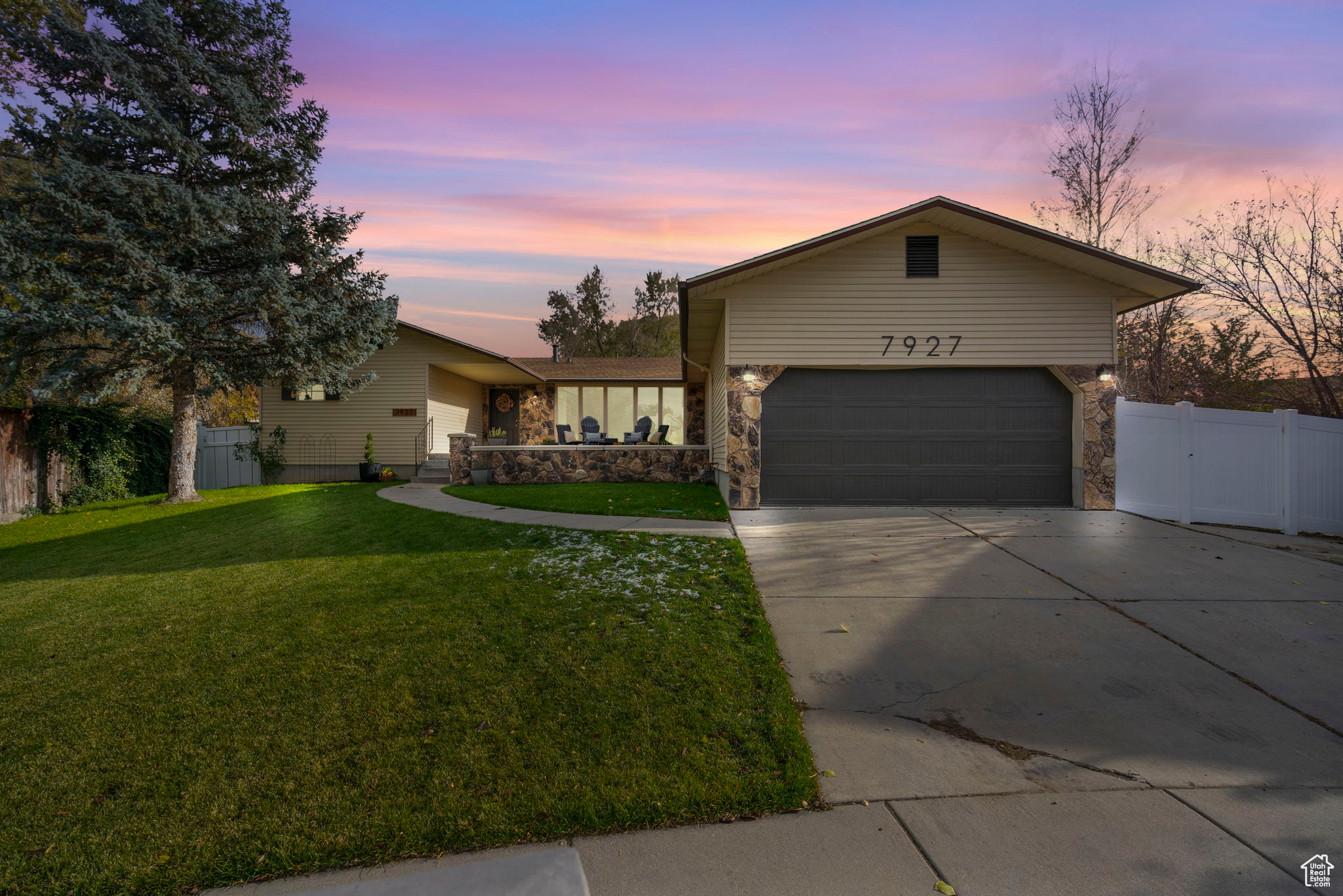 Ranch-style home featuring a yard and a garage