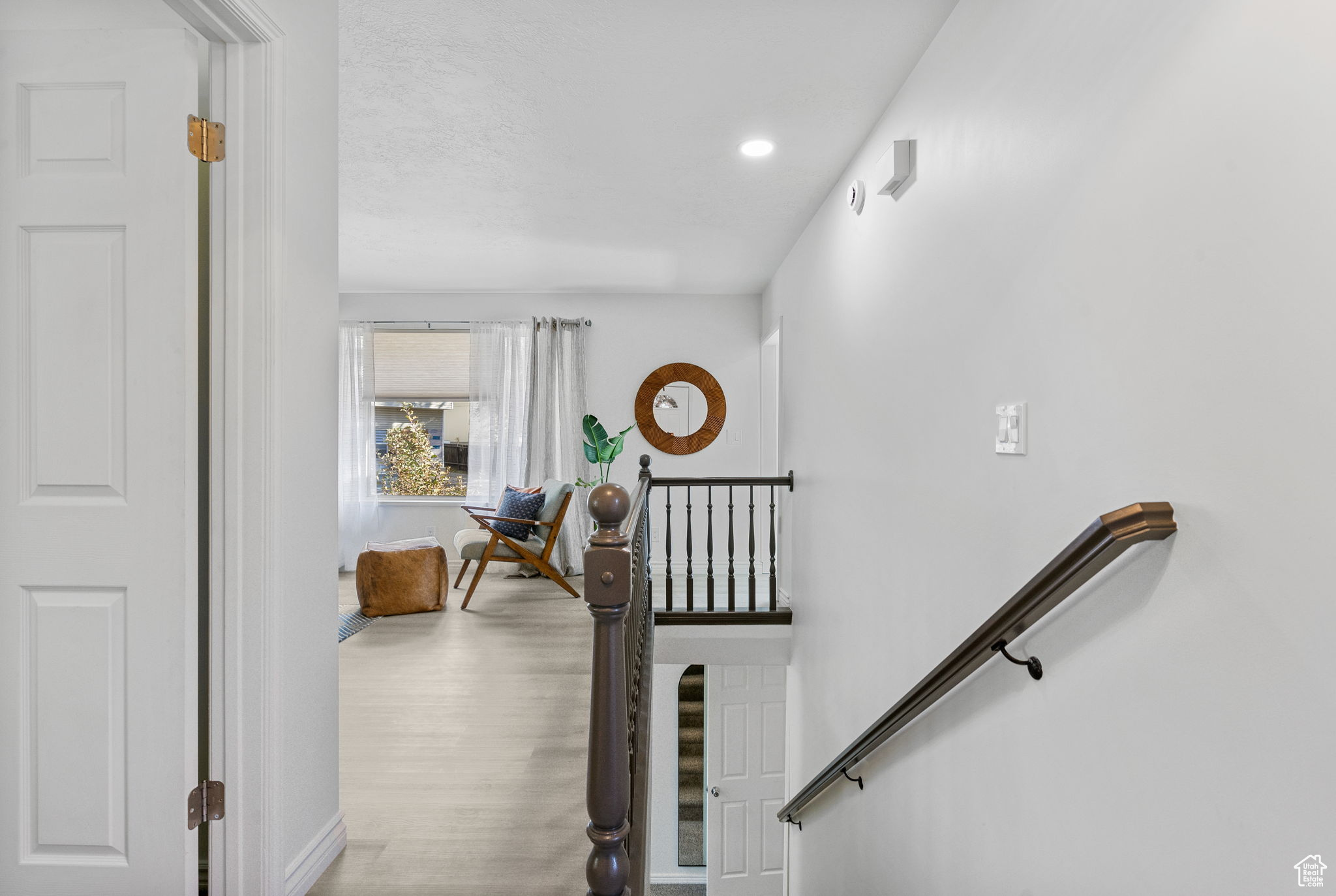 Stairs featuring hardwood / wood-style flooring