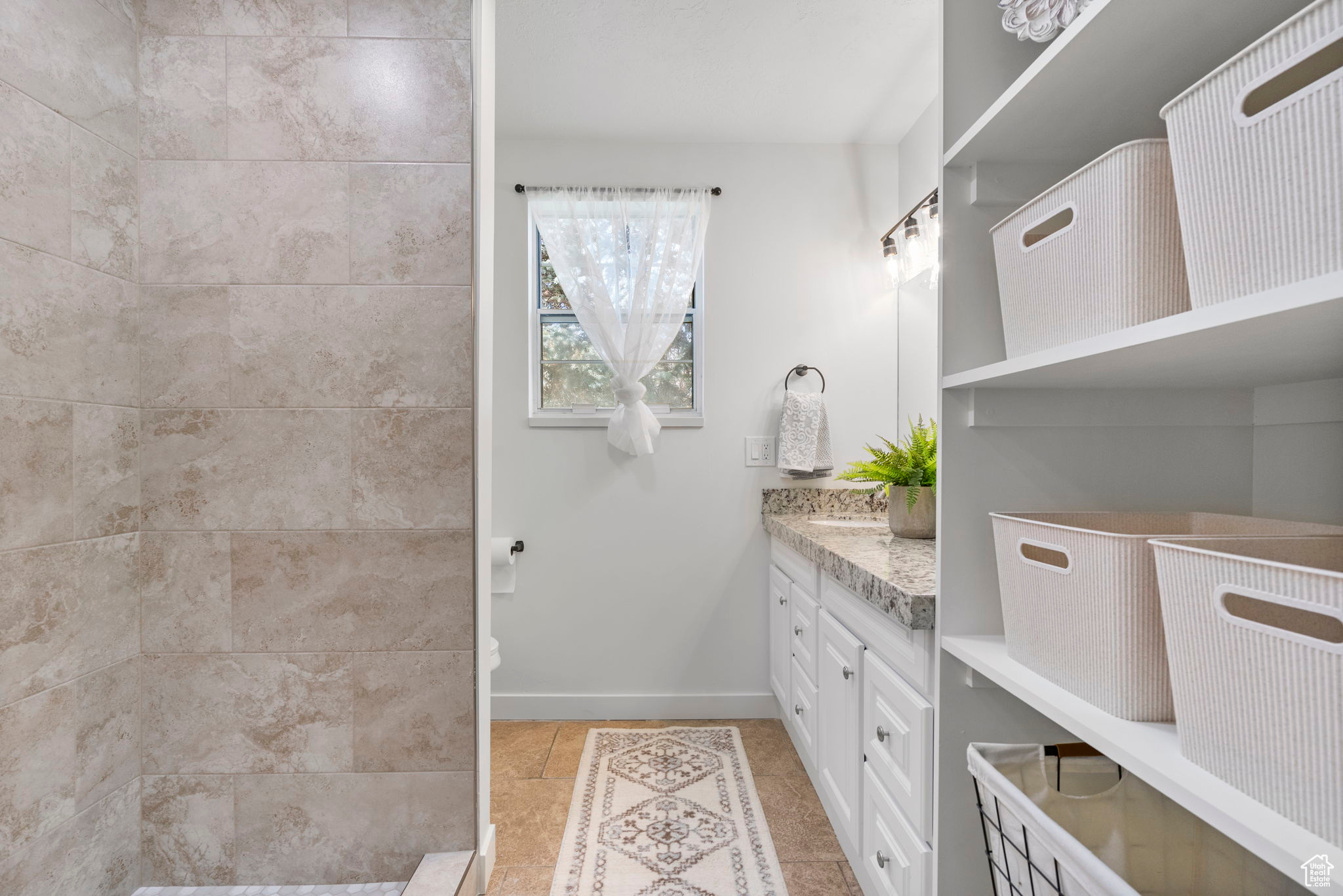 Bathroom with tile patterned floors and vanity