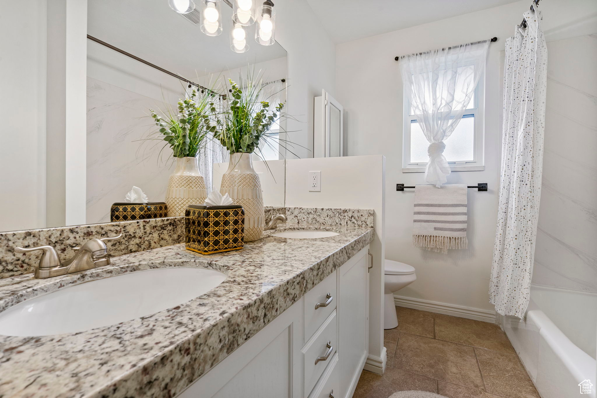 Full bathroom featuring shower / bath combo, toilet, and vanity