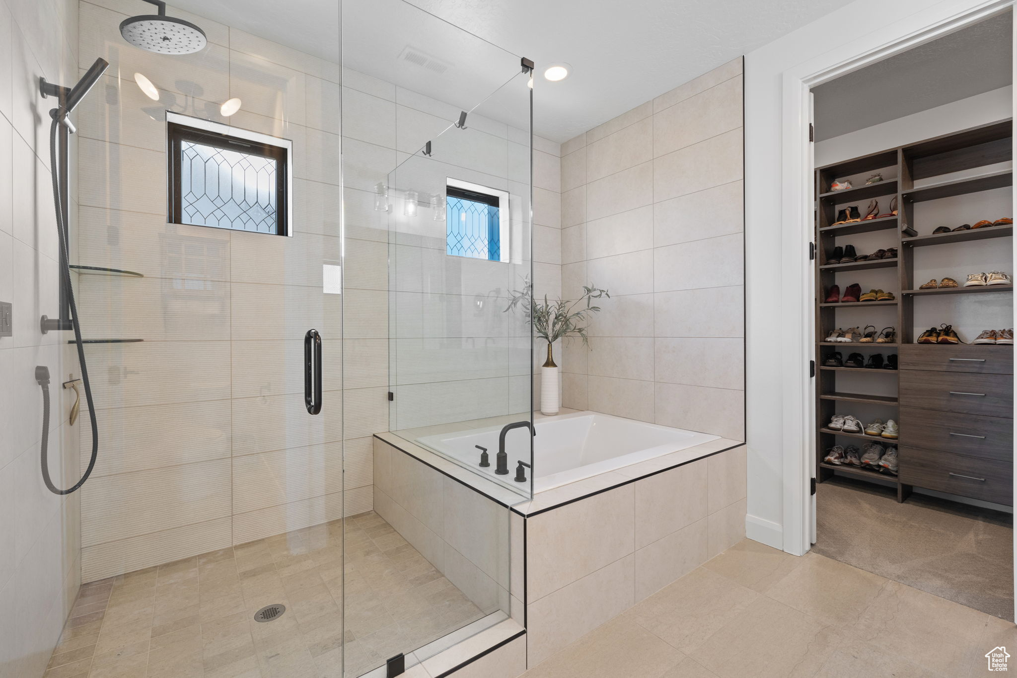 Bathroom featuring plus walk in shower and tile patterned flooring