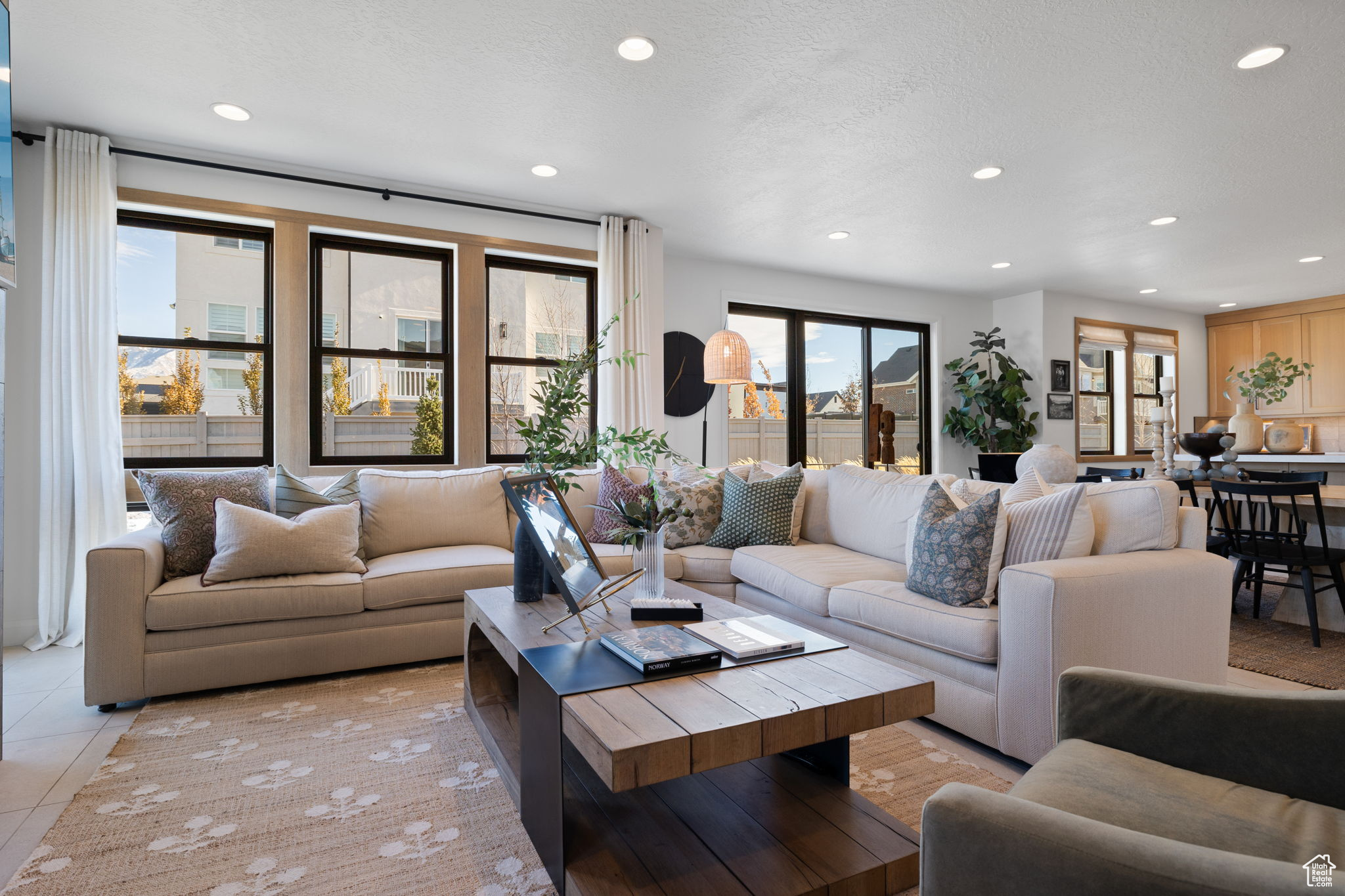 Tiled living room featuring a textured ceiling