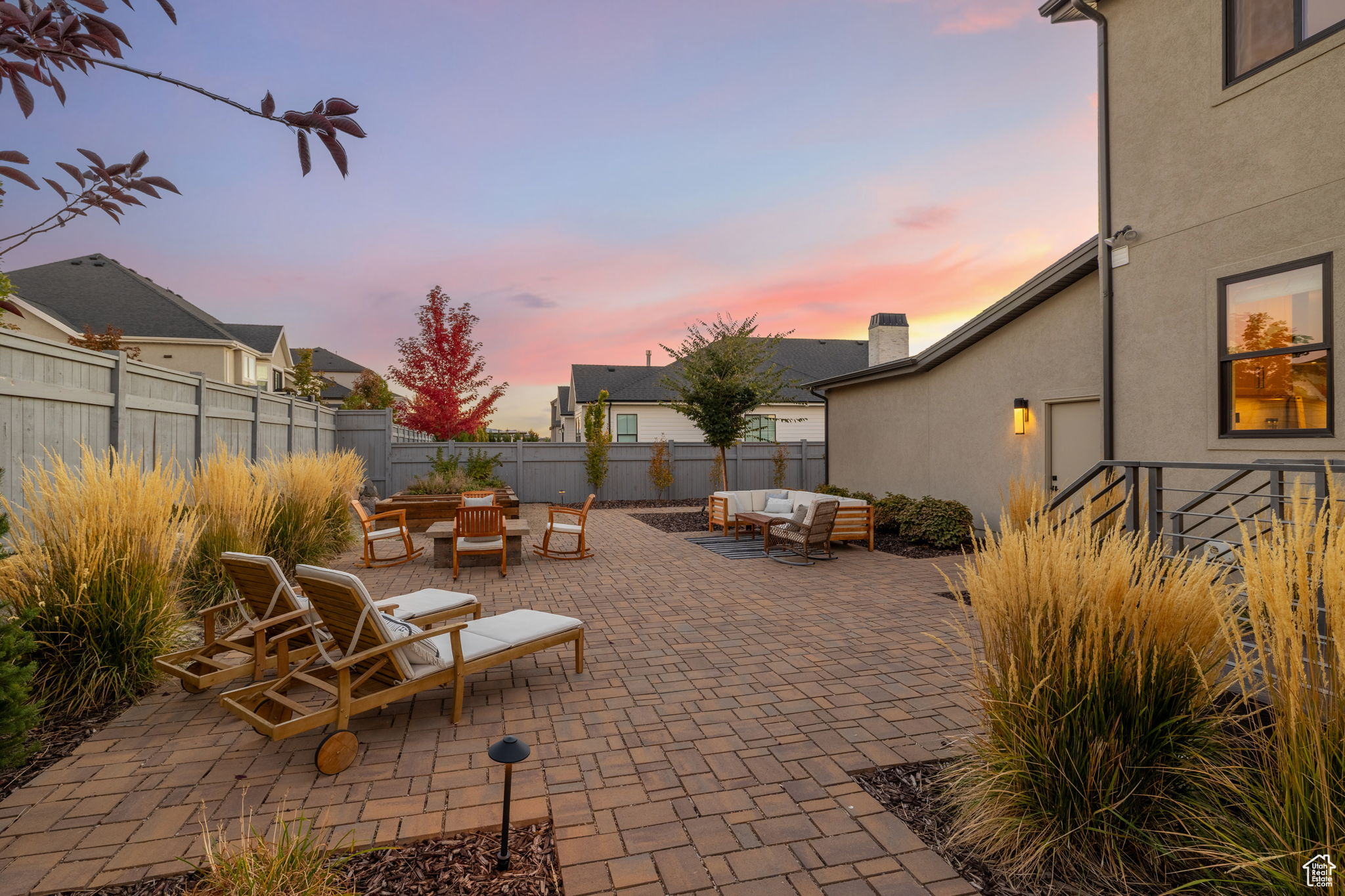 Patio terrace at dusk with an outdoor living space with a fire pit