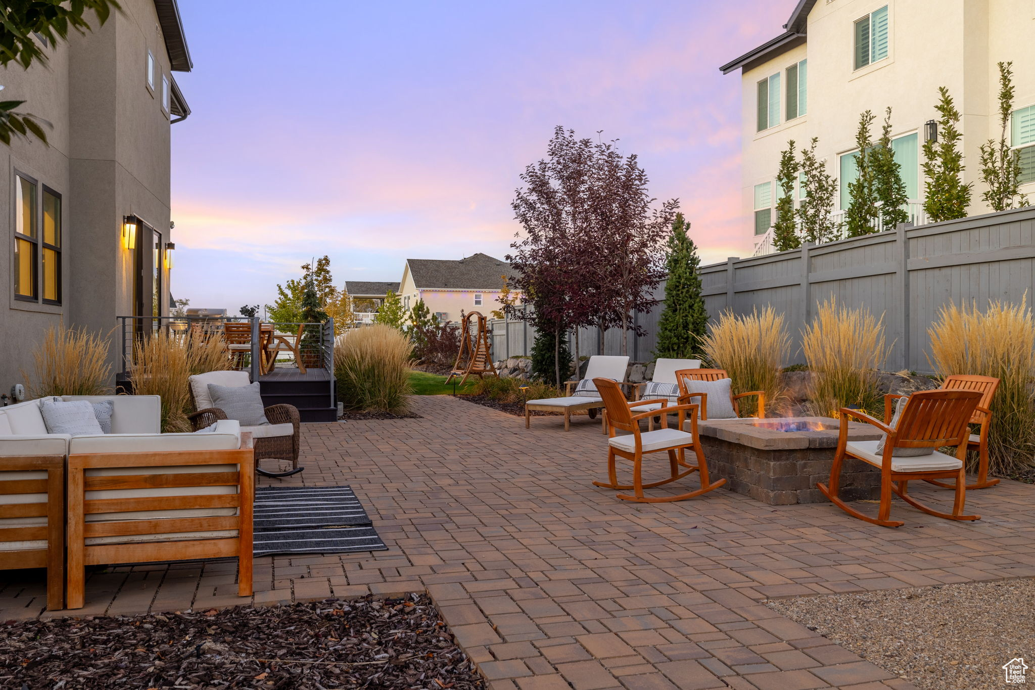 Patio terrace at dusk featuring an outdoor living space with a fire pit