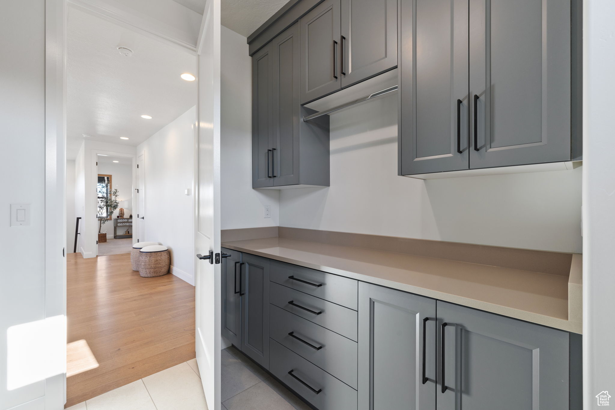 Kitchen featuring gray cabinetry and light hardwood / wood-style flooring