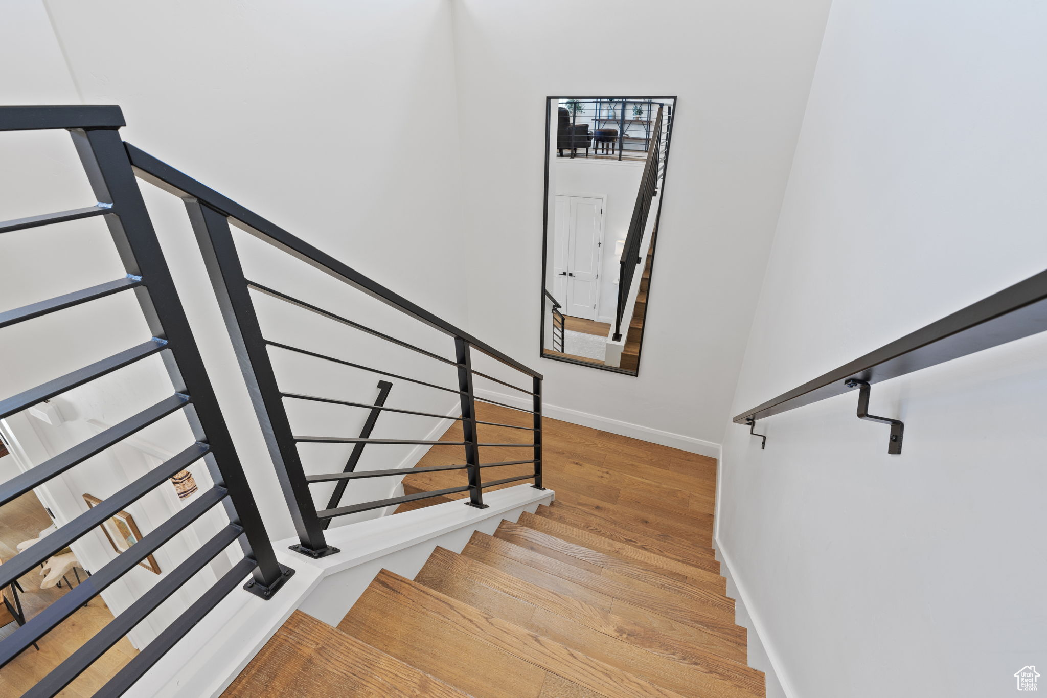 Staircase featuring hardwood / wood-style floors